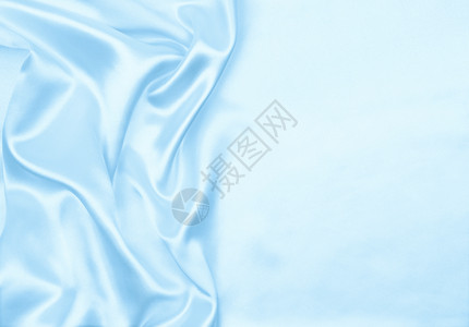 蓝色的布料闪亮平滑优雅蓝色丝绸或席边奢华布质料可用作抽象背景本色设计图片