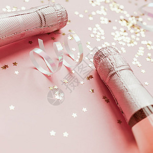 女化圣诞或新年配有玫瑰香槟和金光闪的星彩蛋白在粉色面背景上边观党庆祝会创意概念的歌唱会闪光微背景图片
