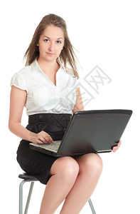 白种人色的年轻女商人坐在椅子上手持笔记本电脑孤立在白色上公司的图片