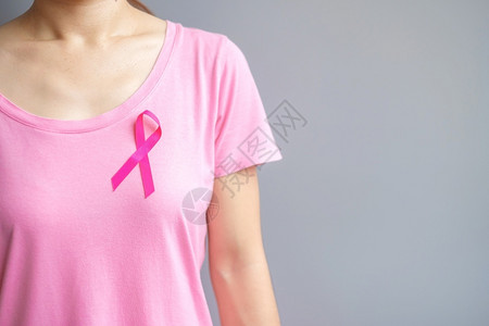 妇女佩戴粉丝带预防癌症概念图片