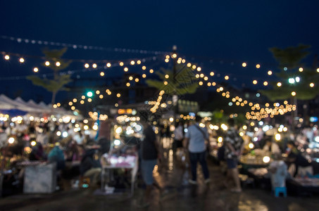 市场公平夏天由人们为背景使用在夜间行走的市场外举行闪亮节活动集市摊位天背景