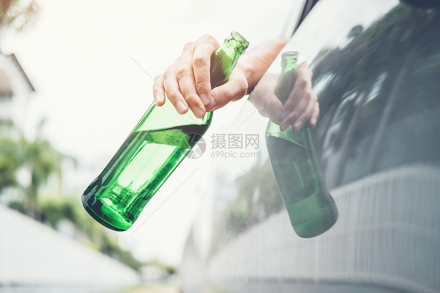 成人睡眠危险的醉酒男子驾驶一辆汽车在路上载着啤酒瓶的车危险醉酒驾驶概念图片