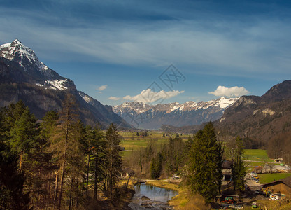 森林封顶具有绿色山谷和雪峰高的惊人瑞士风景新鲜的背景图片