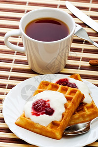 早餐加软华夫饼酸奶油和草莓烘烤的果酱休息图片