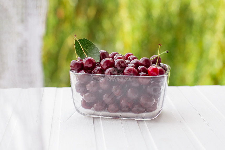 红色的养护窗边玻璃容器中新鲜果子樱桃的夏季收获放在桌子上的玻璃容器里窗边的Berry甜点果汁酱烹饪罐装食品健康图片