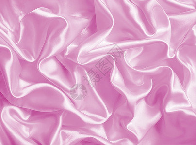 折痕窗帘闪耀平滑优雅的粉色丝绸或纹质可用作背景图片