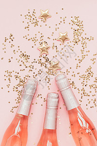粉色发光星星闪亮星星与粉色香槟背景
