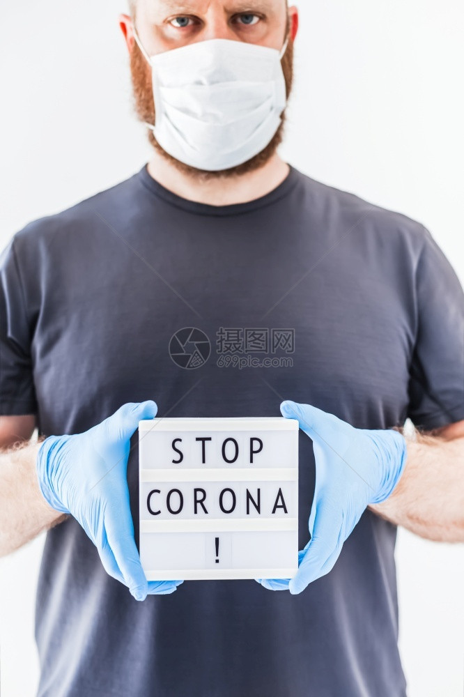 停止使用Coronna概念的发短信灯箱在科罗纳COVID19流行病期间将Corona交给佩戴乳胶医疗手套和保护面具的人信息关心展图片