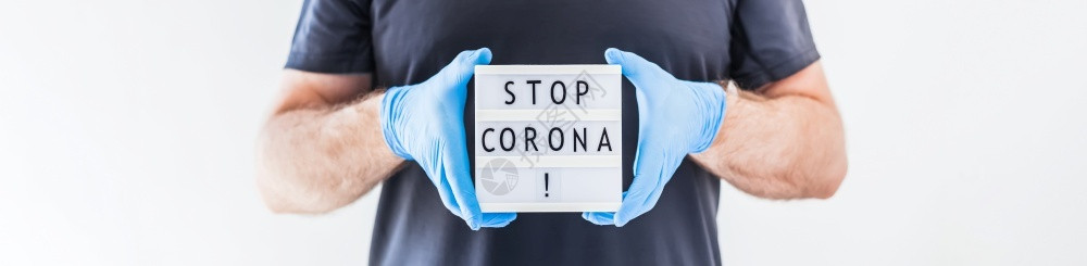 扫黑除恶安灯箱卫生停止使用Coronna概念的发短信灯箱在科罗纳COVID19流行病期间将Corona交给佩戴乳胶医疗手套和保护面具的人预防安背景