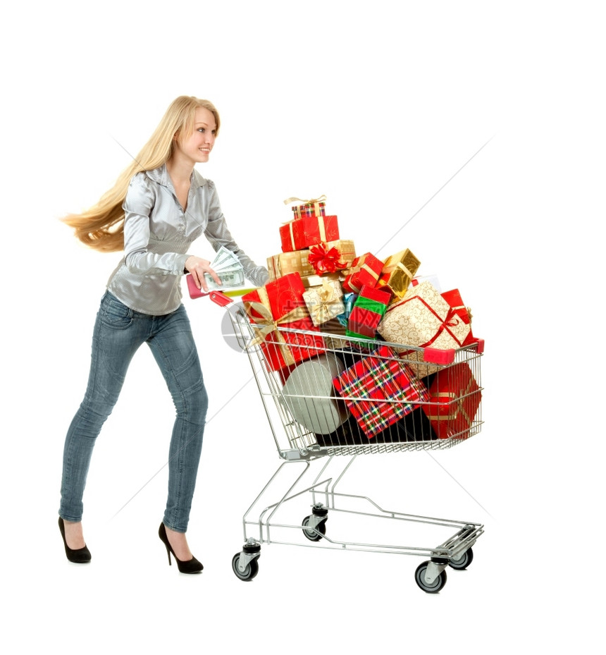 喜悦露齿微笑的年轻女子带着购物盒跑来去里面满是白色背景上不同形状和颜色的礼物盒子愉快图片
