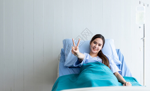 医院病床上微笑的女性图片