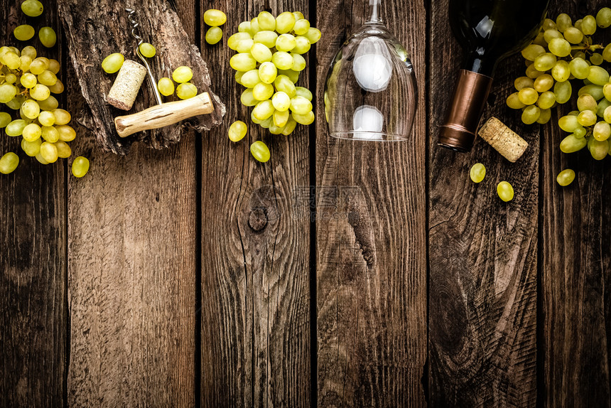 一种意大利语开酒瓶红杯和白葡萄枝叶的开放酒杯和白树枝的背景黑木生锈文字空白液体图片