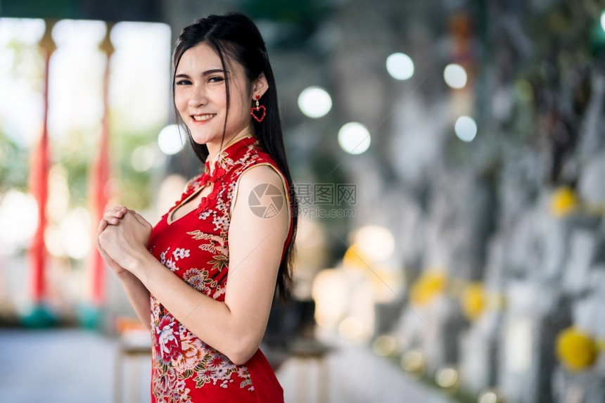 手女身着新年节在泰中神庙举办新年庆典红传统香藏装饰的亚裔年轻女子她的长相笑脸如肖像般美丽传统的图片
