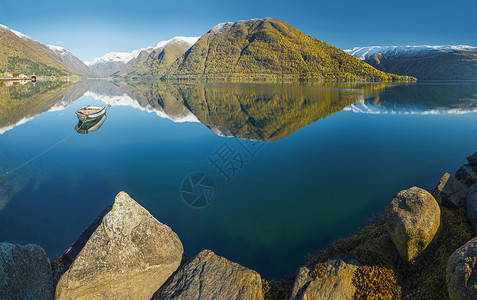户外环境挪威秋季风景的海湾在清澈水和渔船中反映雪积山峰水域和渔船景观图片