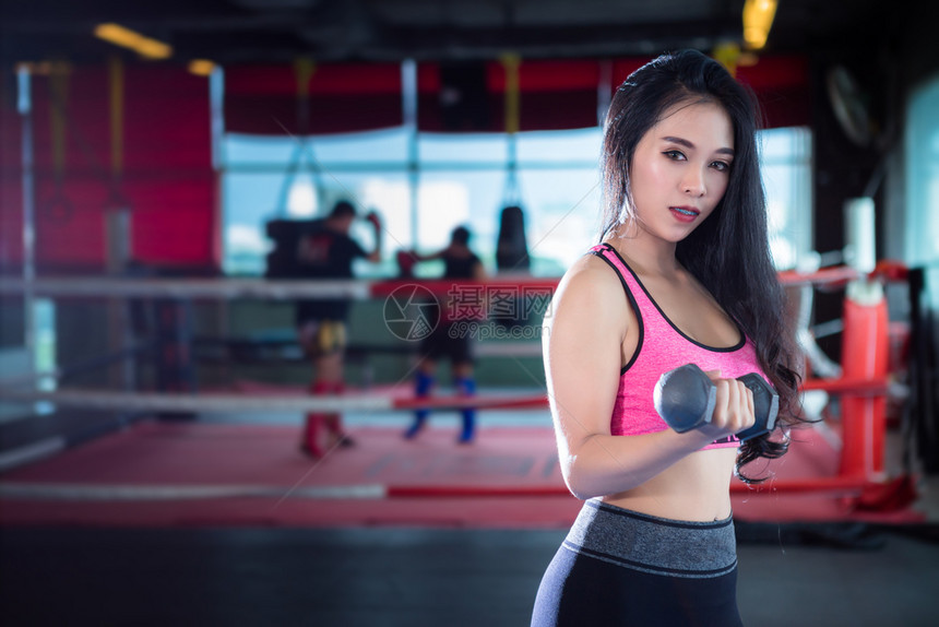 起重室内的亚洲女在体育健身室内运动和俱乐部中进行有哑铃运动的锻练训并配有运动设备体操背景的健身俱乐部亚裔妇女年轻的图片