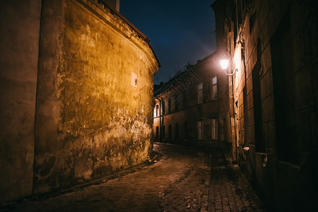 立陶宛语速连科欧洲旅行古老的狭窄夜晚有旧建筑和冬季背景的维尔纽斯街背景