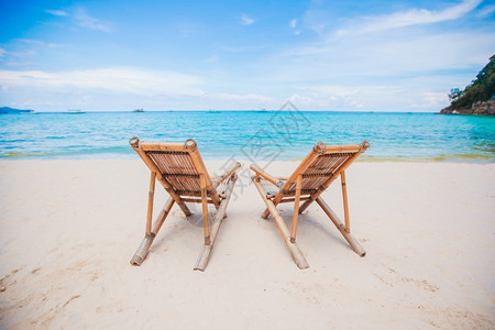 宁静天堂逃离美丽的热带海滩上木制躺椅美丽的热带海滩上白色躺椅图片