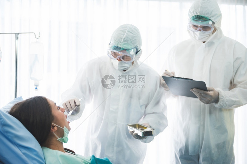 医院里身穿防护服的医生给病人治疗图片