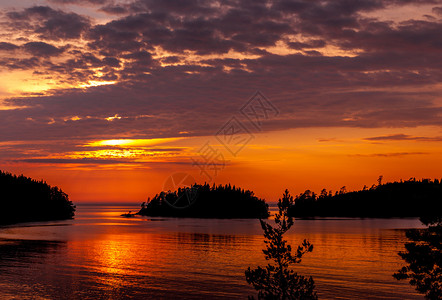 斯凯里岛卡累利阿拉多加海日落在湖边太阳从云中升出光的芒是明亮暗影在月色之夜黄昏时湖面的全景背景