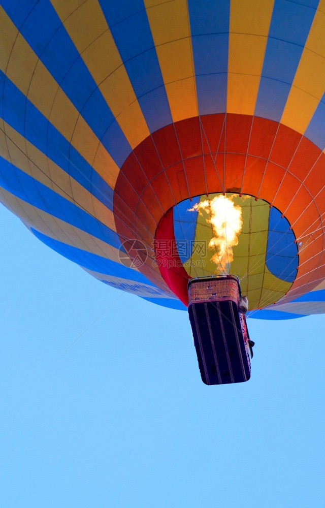 天线在热气球中飞行燃烧炉火的焰使空气发热用篮子向天空升起气球紧闭低视底部复制空间一个气球与篮子的垂直图像碎块一个燃气器点空的火焰图片
