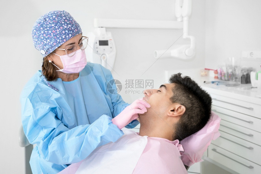 在牙科诊所治疗的男患者图片