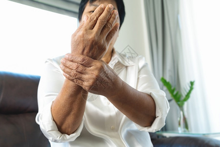 女士不舒服老年妇女的手腕疼痛高龄概念的保健问题拉伸图片