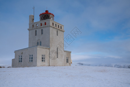 自然半岛Dyrholaey角灯塔全景图像冰雪和清晨光照冰岛冬季日出图片