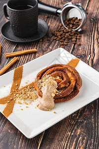 盘子圆形的螺旋苹果蛋糕或松饼在木本底加一杯咖啡新鲜填充图片