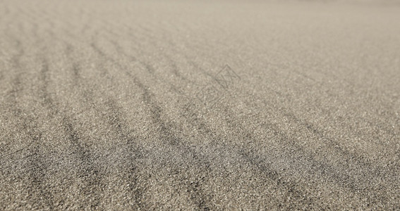 户外金子热横跨框架的卷状灰色沙子选择焦点在整个框架的卷状灰色沙子图片