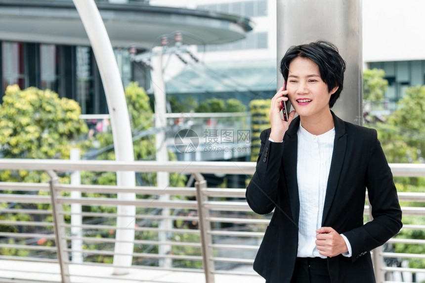 亚洲人自信的使用智能手机在线购物打电话发短信互联网技术生活方式的女商人使用手机在城市街道上行走智能手机自信女现代城市聪明的图片