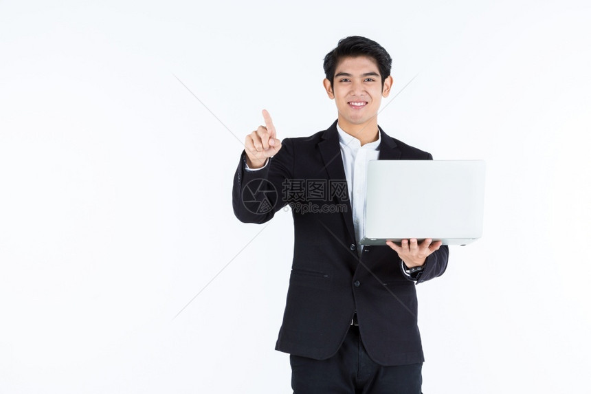 一个成功的企业拥有笔记本电脑手触摸用白色灰空间工作室背景所隔离的图像面板成功获得Asian青年商人的快乐指点空白控制板图片