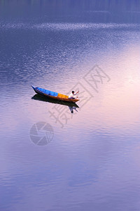 黄昏时有一艘渔船在湖中游荡风景生态人们运动高清图片素材