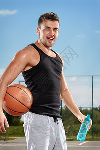 乐趣积极的健康运动场上饮用水的篮球运动员口渴图片