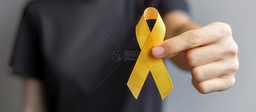 预防日Sarcoma骨膀胱和儿童癌症意识月支持生活和患病儿童保健世界癌症日概念的黄丝带健康护理和世界癌症日概念黄色的团结一致弓图片