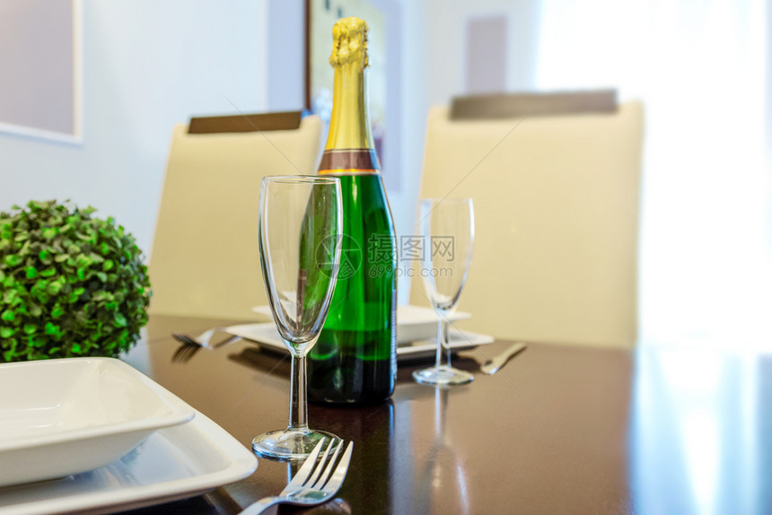 浪漫午餐两在厅或客复制空间的餐桌上用一瓶香槟和戴眼镜的玻璃杯红酒浪漫的图片