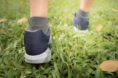 慢跑者行动晚上日落时穿运动鞋在中央公园跑步的女运动员穿着鞋活图片