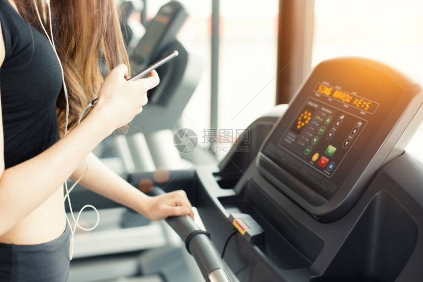 运动的亚洲女在健身房运动锻炼或体力训练时使用智能电话有关运动放松和技术概念运动和健康护理主题快乐与舒适的心情光线燃烧图片