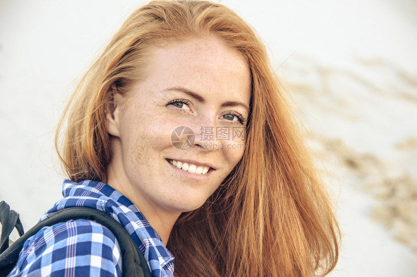 穿着红头发和雀斑衣的时装髦年轻女孩的肖像穿着红色头发和短裤穿着在斜坡沙丘上的格斗衬衫背包旅行徒步和积极生活方式概念享受斜坡沙丘太图片