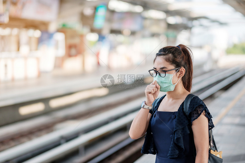 女青年在公共火车站戴着口罩图片
