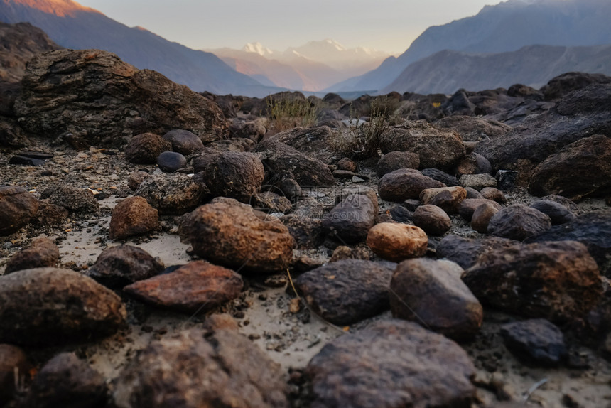 远足巴基斯坦GilgitBaltistan的Sunset背景象对卡拉科姆山脉岩石巨和块的自然粗地风景图阳光观图片