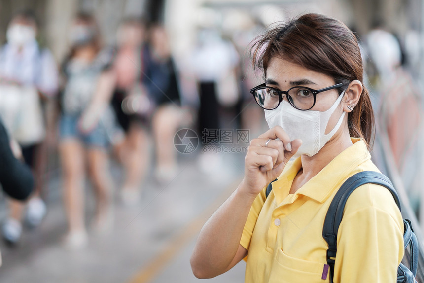 在公共场所佩戴口罩的青年女性图片