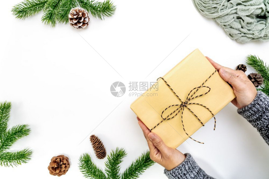传统妇女手拿着圣诞礼物盒有松锥白色背景上的圆枝白底面红花枝顶视图复制空间丰富多彩的躺着图片