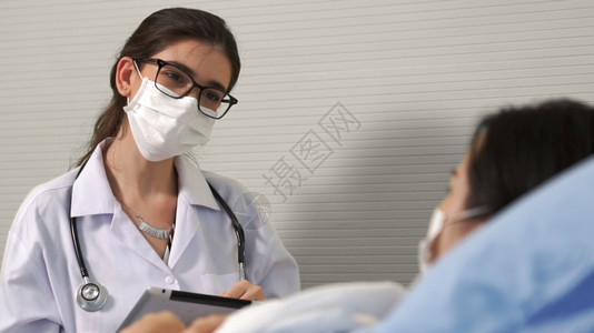 戴口罩的医生关心住院病人图片