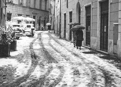 罗马伞追踪意大利罗马2018年月6日意大利罗马雪灾期间带伞的2018年第6届老女士在一条小巷里散步白色的寒冷背景