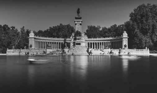 西班牙航海纪念碑运动西班牙马德里的阿方索十二世纪念碑对面的人在船上单色长时间曝光该公园被称为西班牙马德里的宜人静修公园delBuenRetiro背景