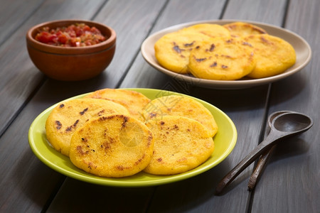 阿雷帕斯勺子乡村两盘有哥伦比亚番茄猪酱和红洋葱的黄或白玉米由饭制成传统上在哥伦比亚和委内瑞拉选择焦点组织PeciveFocusonthe背景