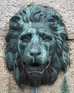狮子面具风化花岗岩雕塑石头古铜色古董动物建筑学金属青铜背景图片