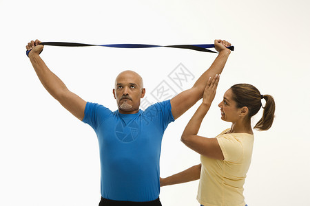 女人和男人的锻炼男性教练力量女性男子中年人两个人照片弹力私人背景图片