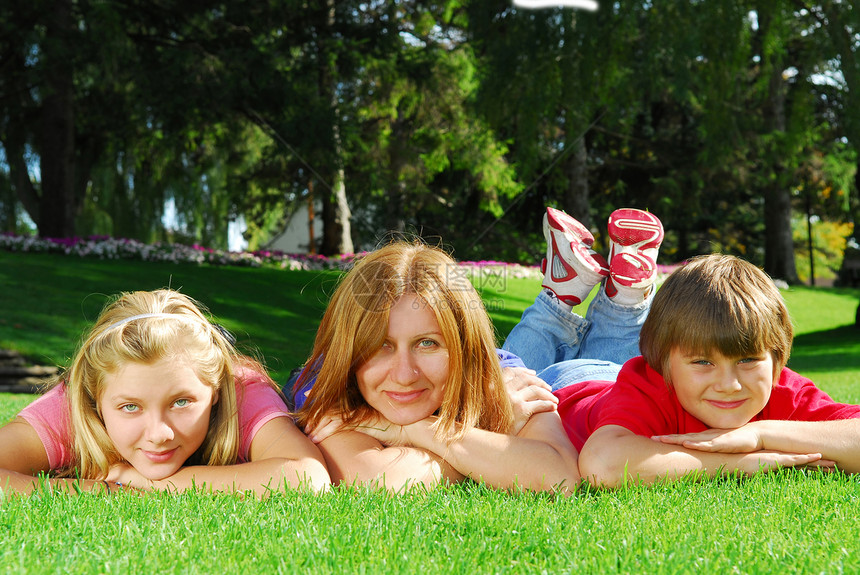 家庭放松娱乐父母绿色儿子女孩女性童年母亲公园女儿团体图片