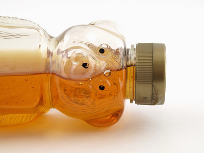 蜂蜜熊素材半满蜂熊瓶子蜜蜂白色琥珀色塑料背景